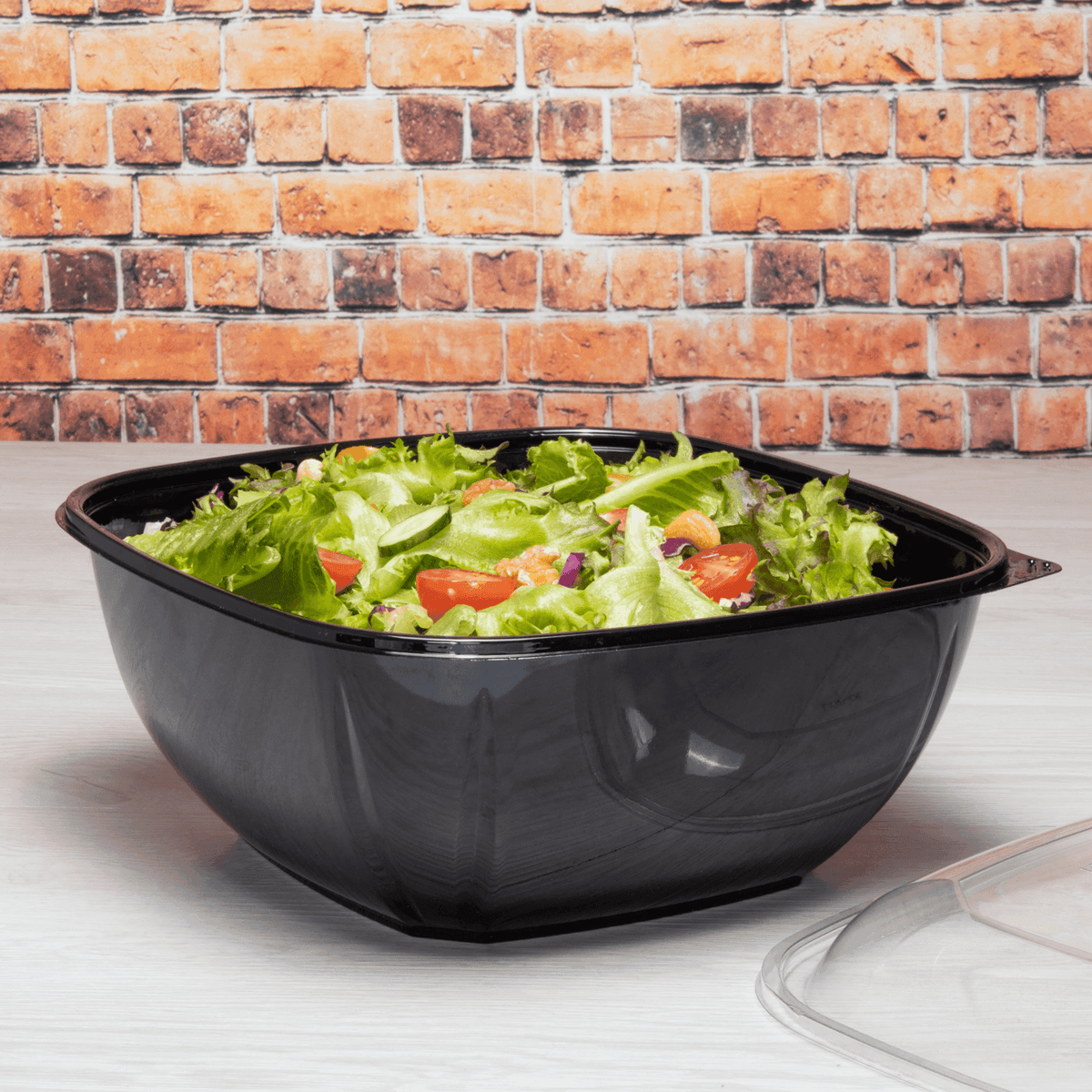 160 oz black PET square salad bowl filled with salad