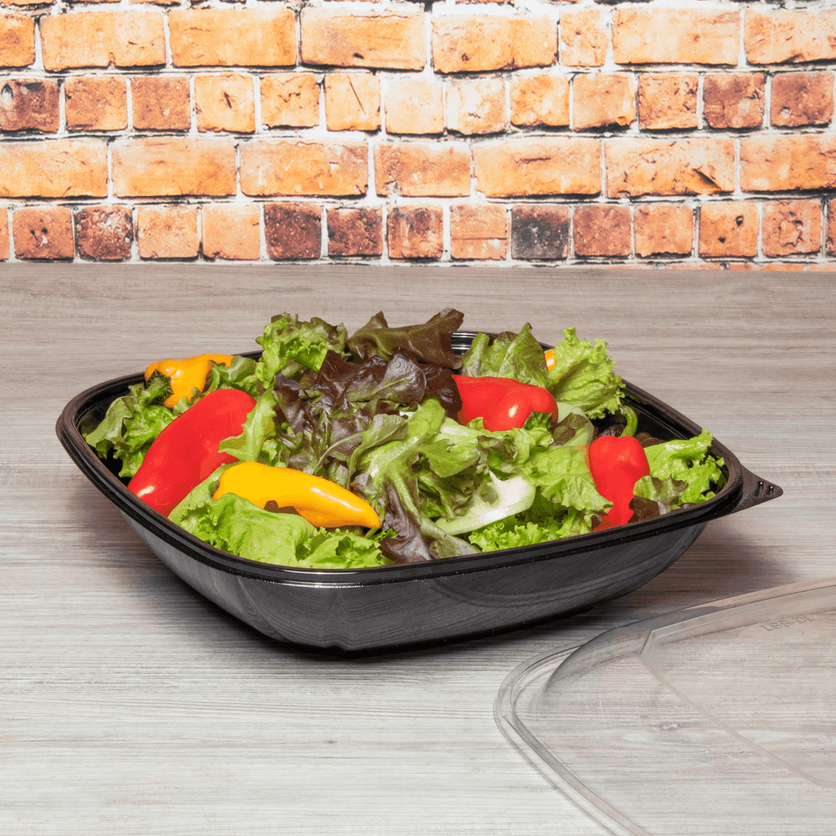 80 oz black PET square salad bowl with food