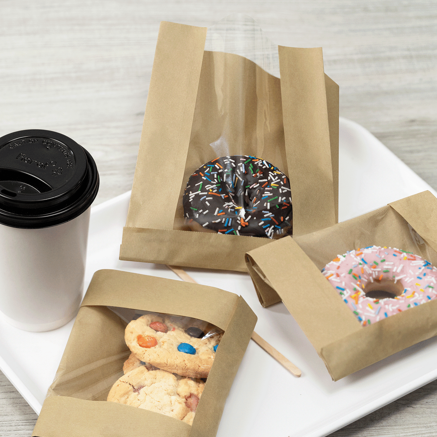 Kraft paper pastry bag with clear window holding baked goods, 1000 ct case